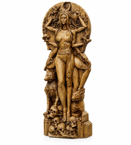 A detailed wooden sculpture of a multi-armed female deity standing atop a base of skulls, flanked by wolves, set against a plain white background.