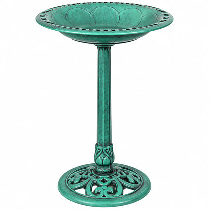A green metal pedestal bird bath with a scalloped rim, decorative filigree base, and textured finish, shown on a plain white background.